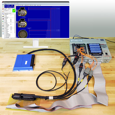 Harness tester comprising a Control Module with attached expansion modules and test interface fixture with motorport UUT attached.